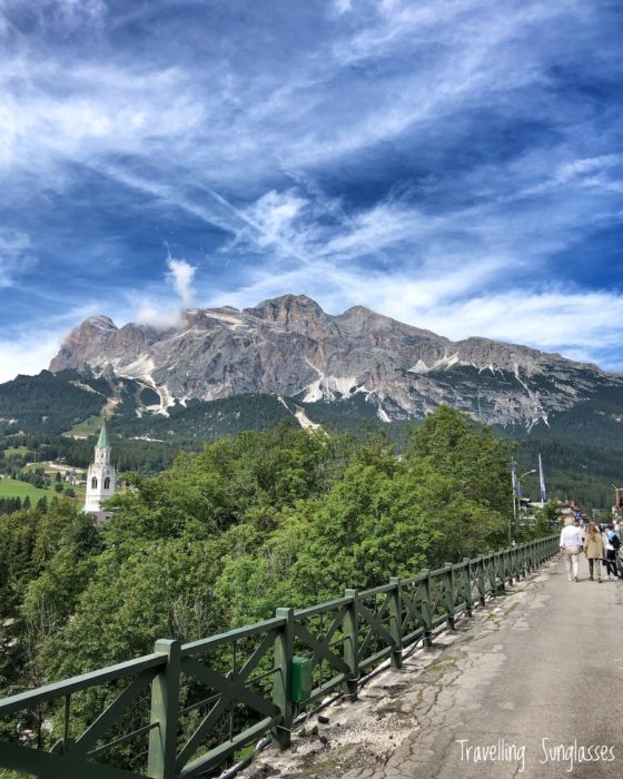 View of Tofana and bell tower from Old Railway bridge Cortina